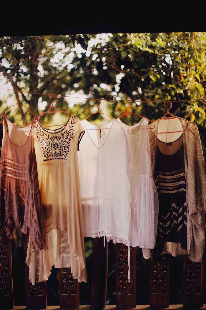 The Art of Drawing Readers In: Your attractive post title goes here Vintage bohemian dresses on hangers outside in natural light, for a rustic fashion theme.
